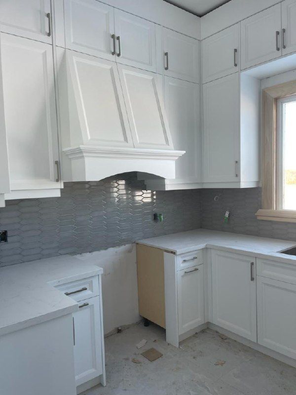 Grey picket-tile kitchen backsplash with custom hood