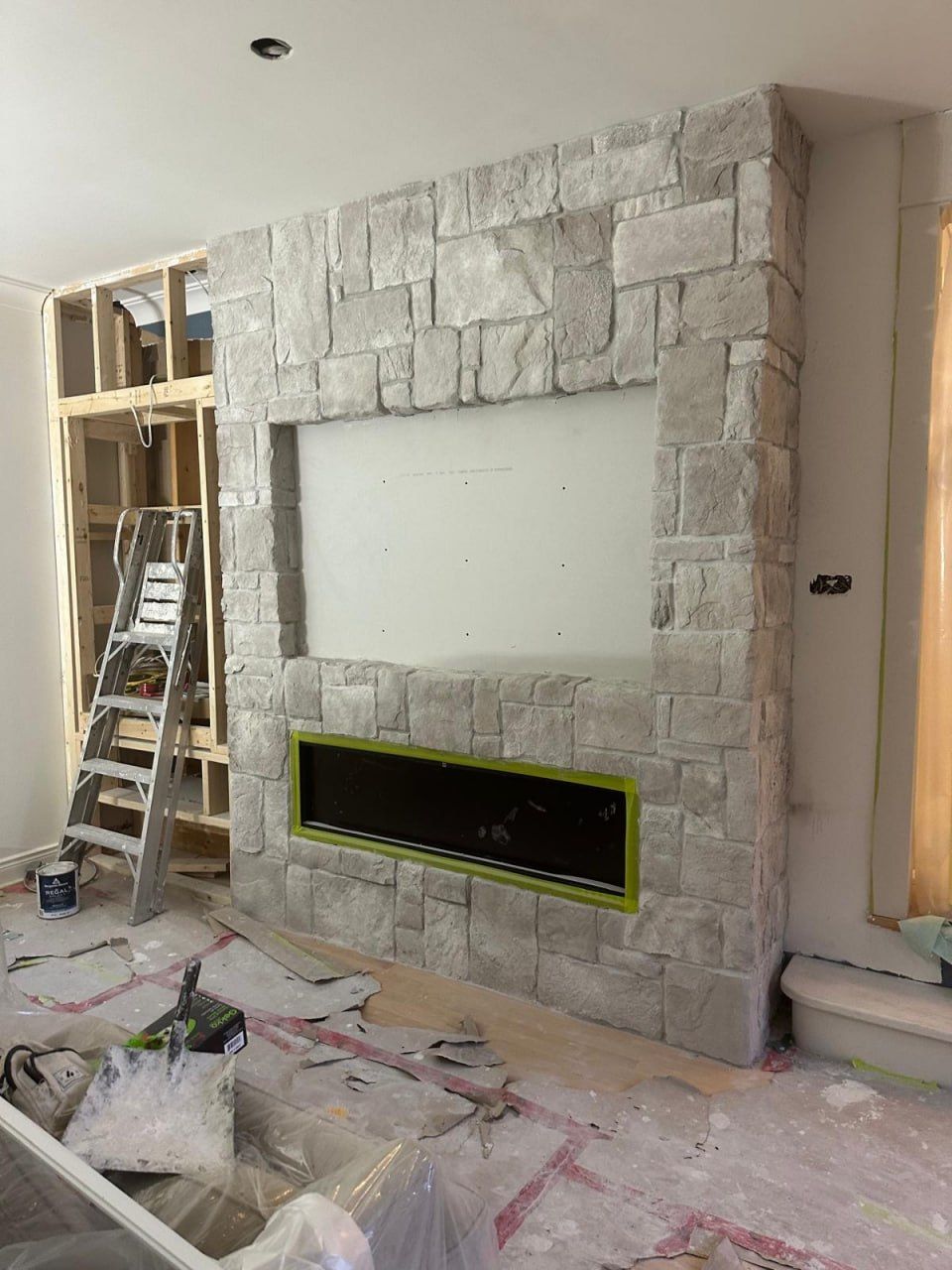 Natural stone fireplace build with linear insert