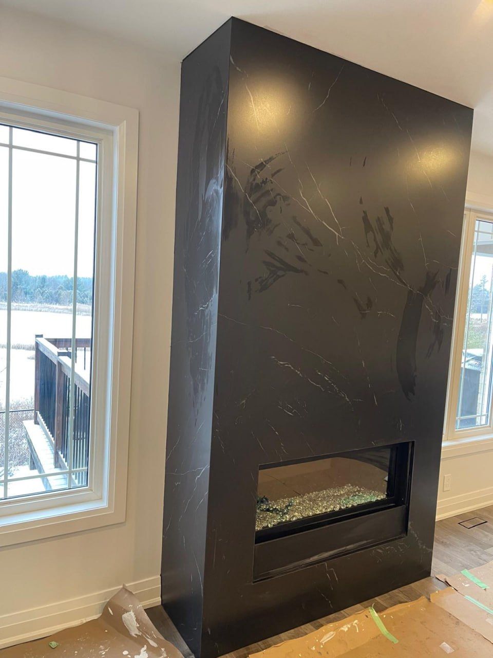 Black marble floor-to-ceiling fireplace