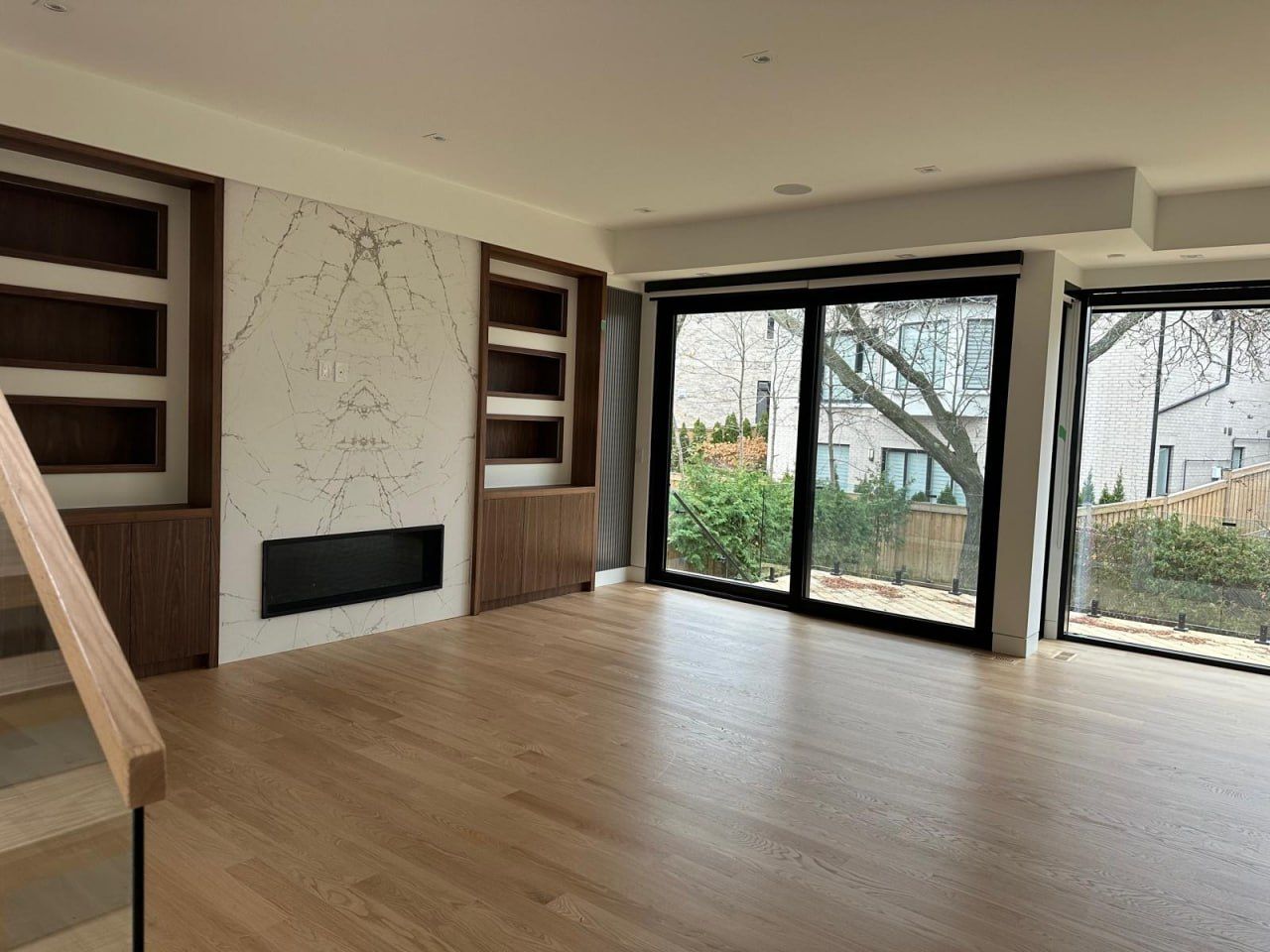 Custom marble fireplace with walnut built-in shelving
