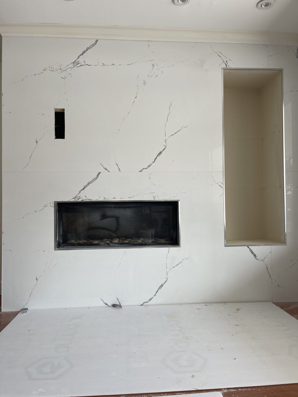 Marble fireplace wall with built-in niche in progress