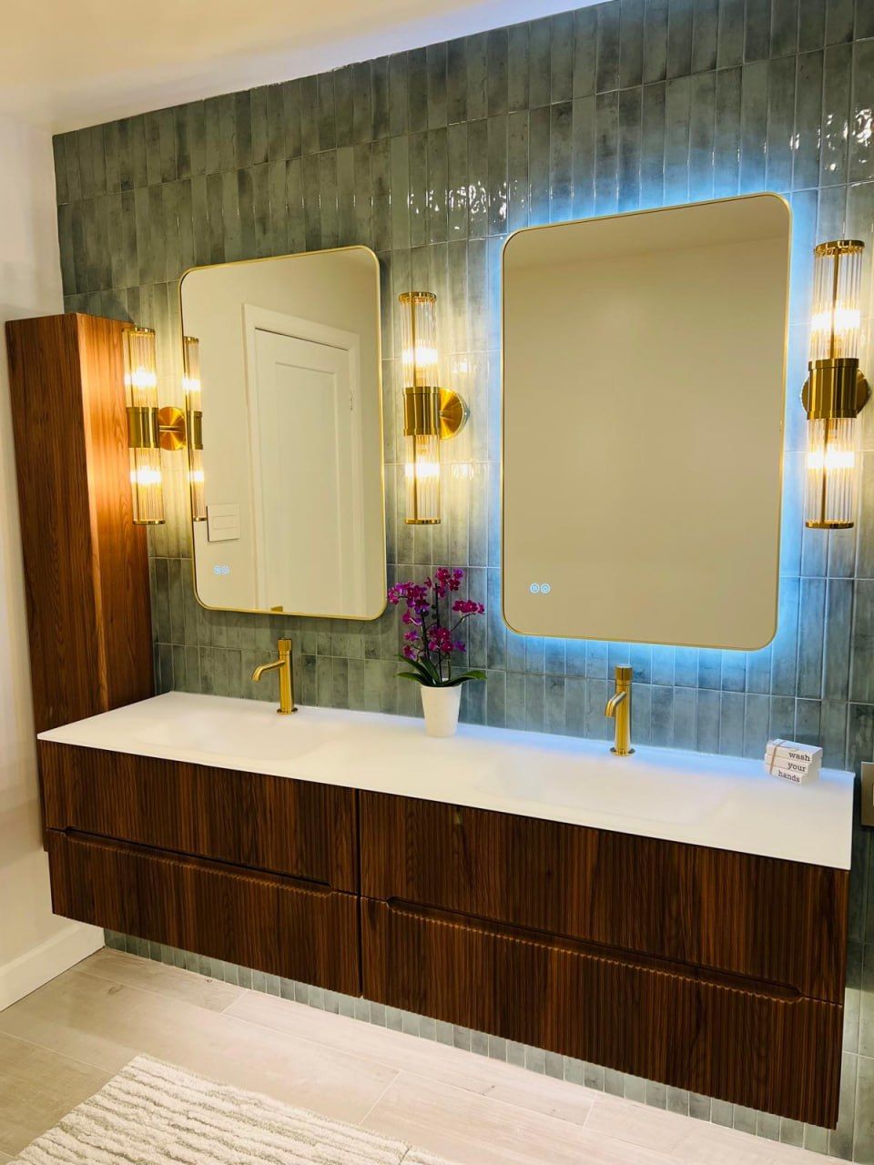 Green-tile double vanity with walnut cabinetry and LED mirrors
