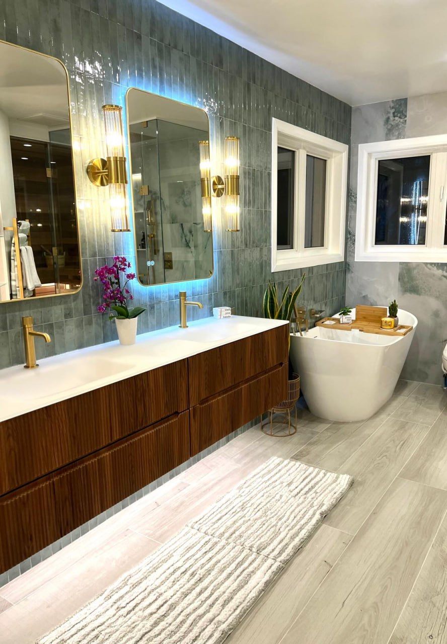 Green-tile bathroom with freestanding tub and wood-look floor
