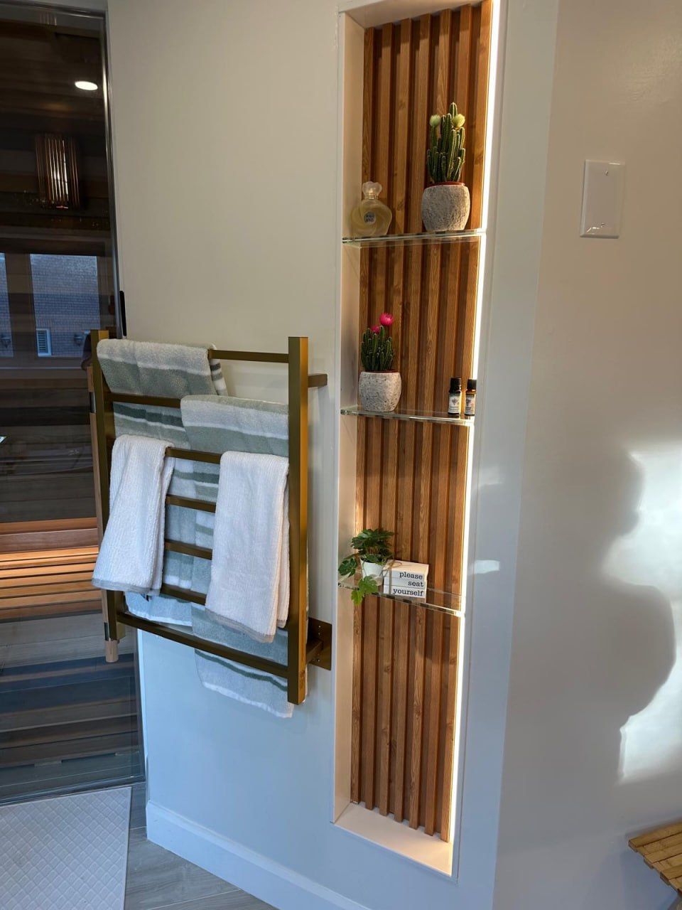 Cedar slat feature niche with glass shelving and towel rack