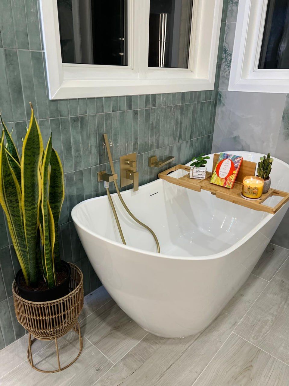 Freestanding soaker tub with brushed gold tub filler