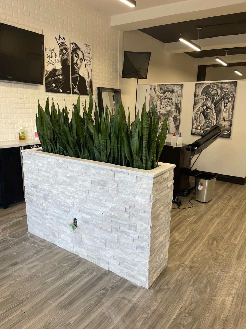 Commercial fit-out with stacked-stone reception and wood-look flooring