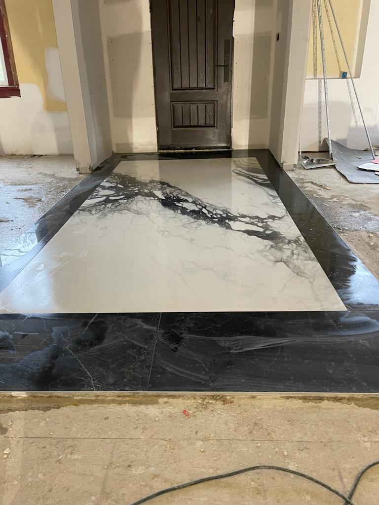 Book-matched marble floor medallion at an entryway