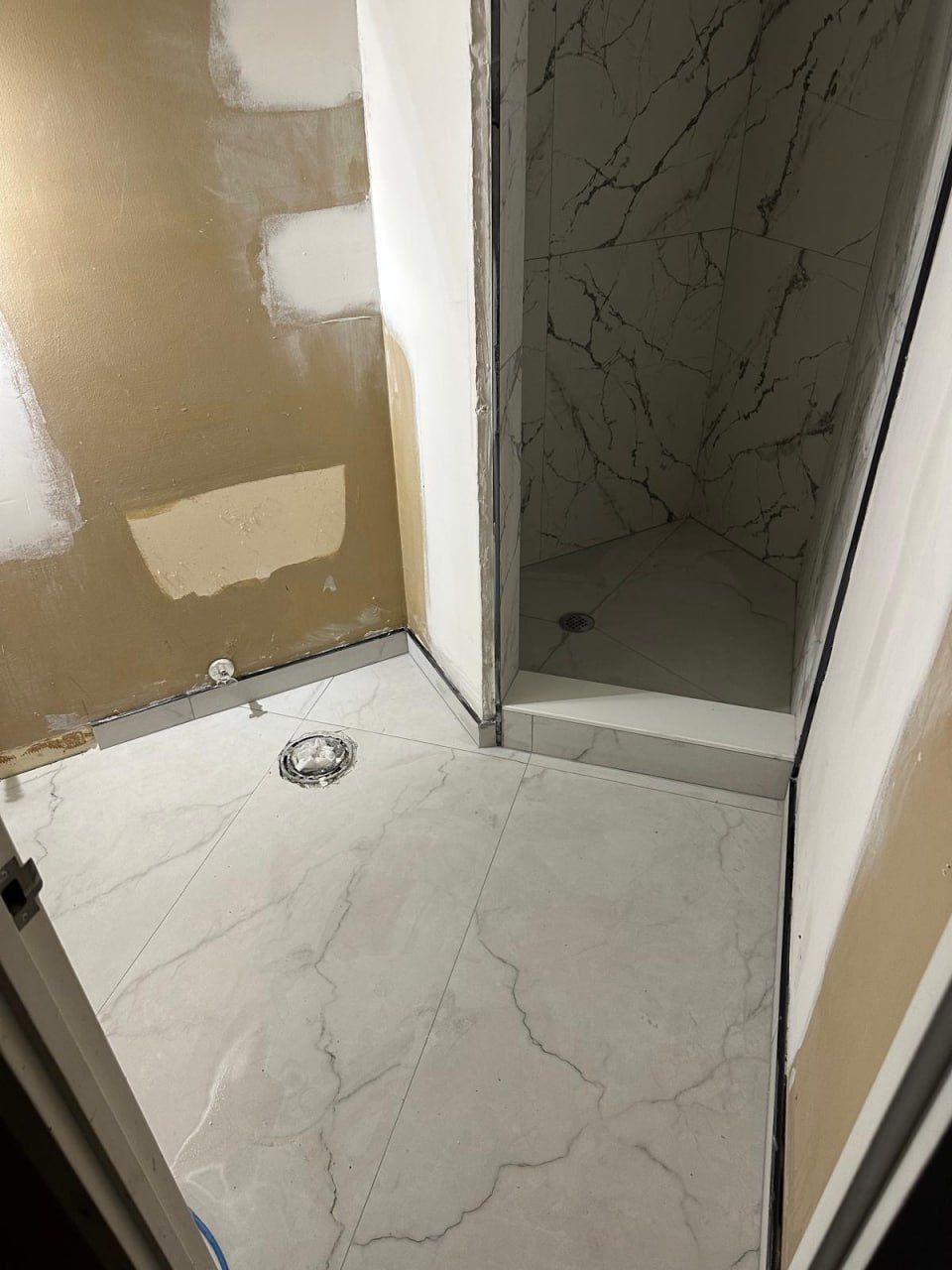 Marble floor and shower base set before finishing