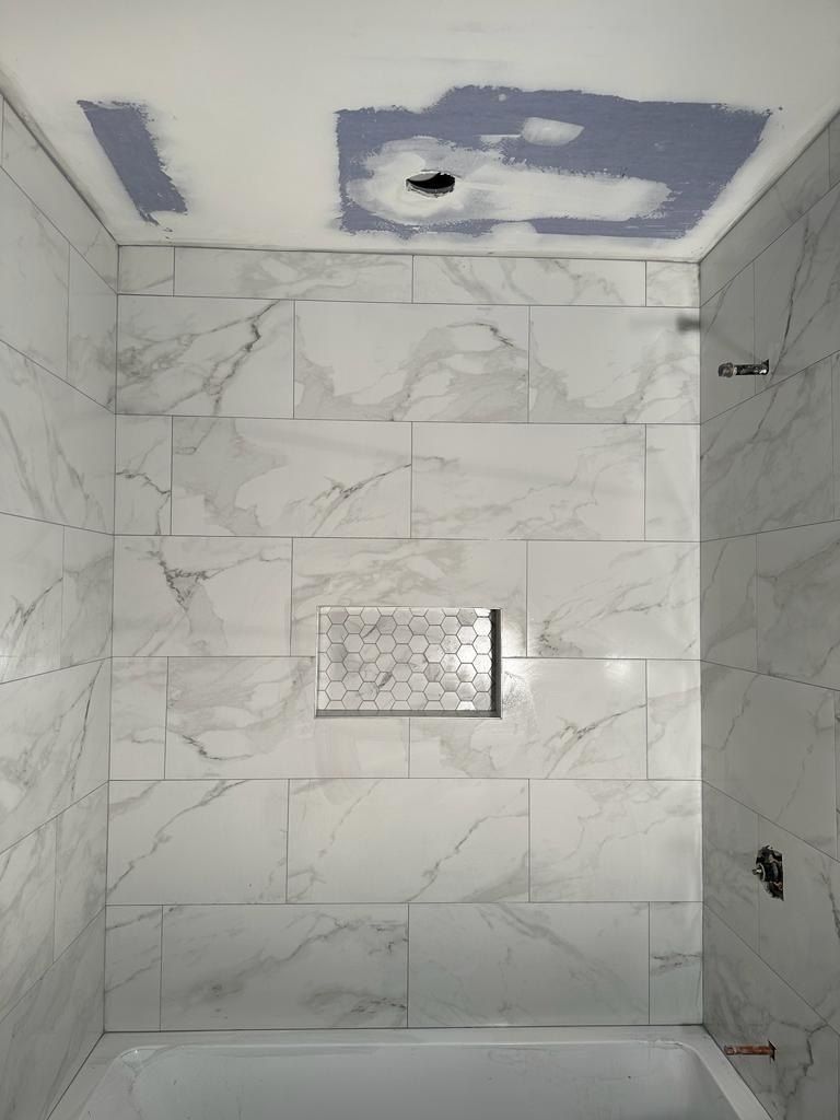 Marble tub surround with hexagon mosaic niche in progress