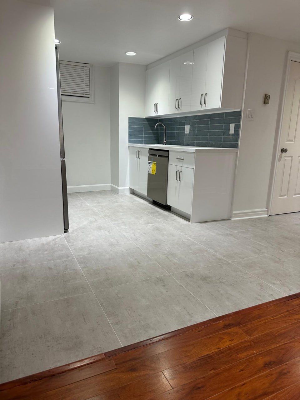 Compact kitchenette with blue tile backsplash