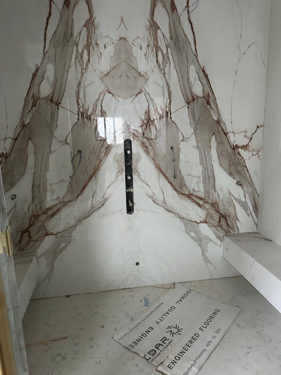 Book-matched Calacatta Viola marble shower wall
